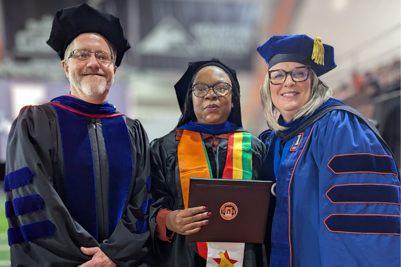 grad student and two professors at graduation