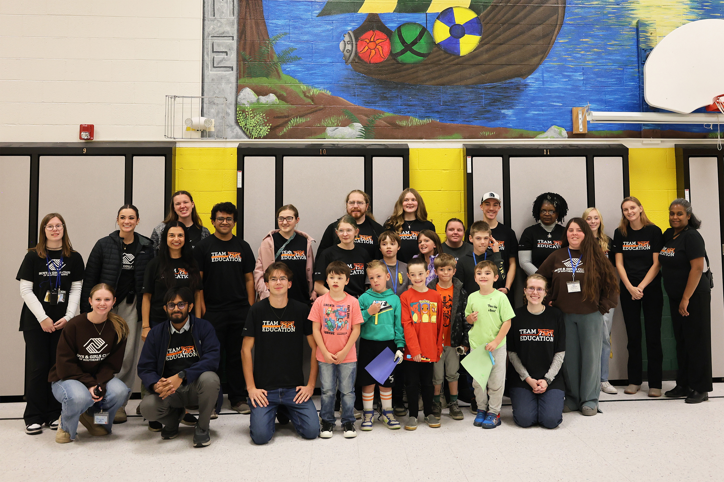 Students and faculty posing together with kids from the Boys and Girls Club