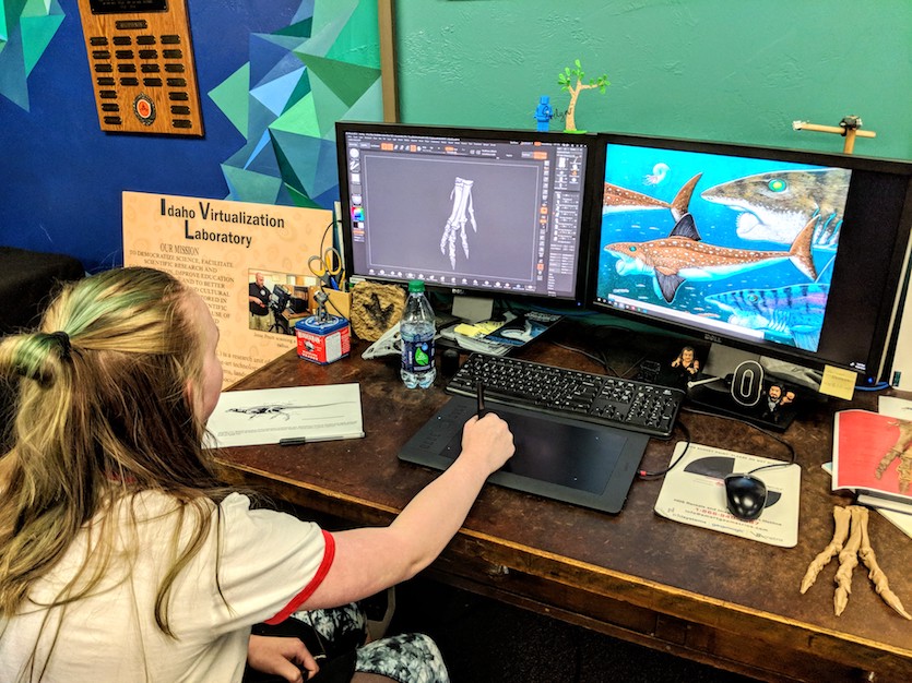 Child working on computer to create digital dinosaur