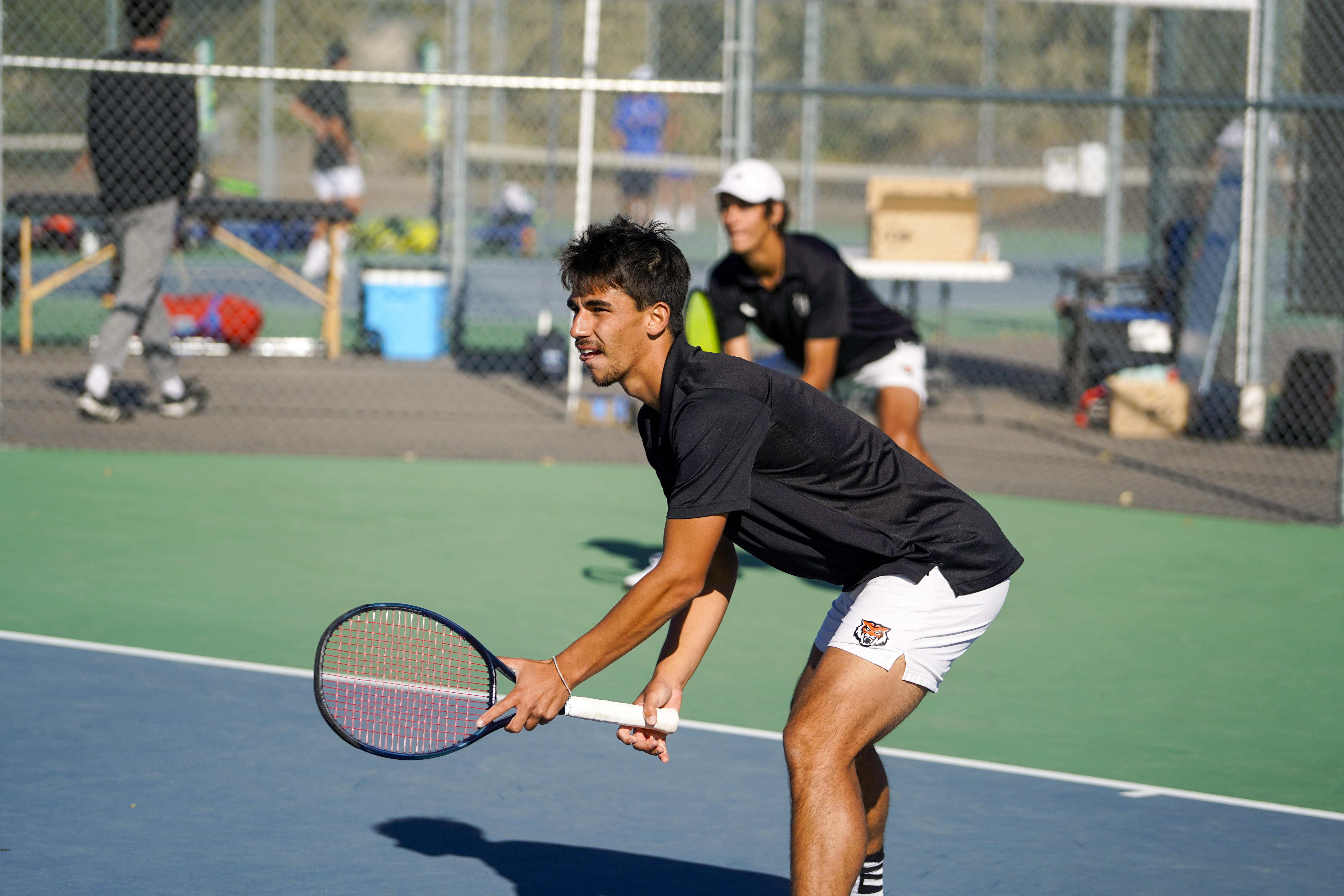 Male students playing tennis