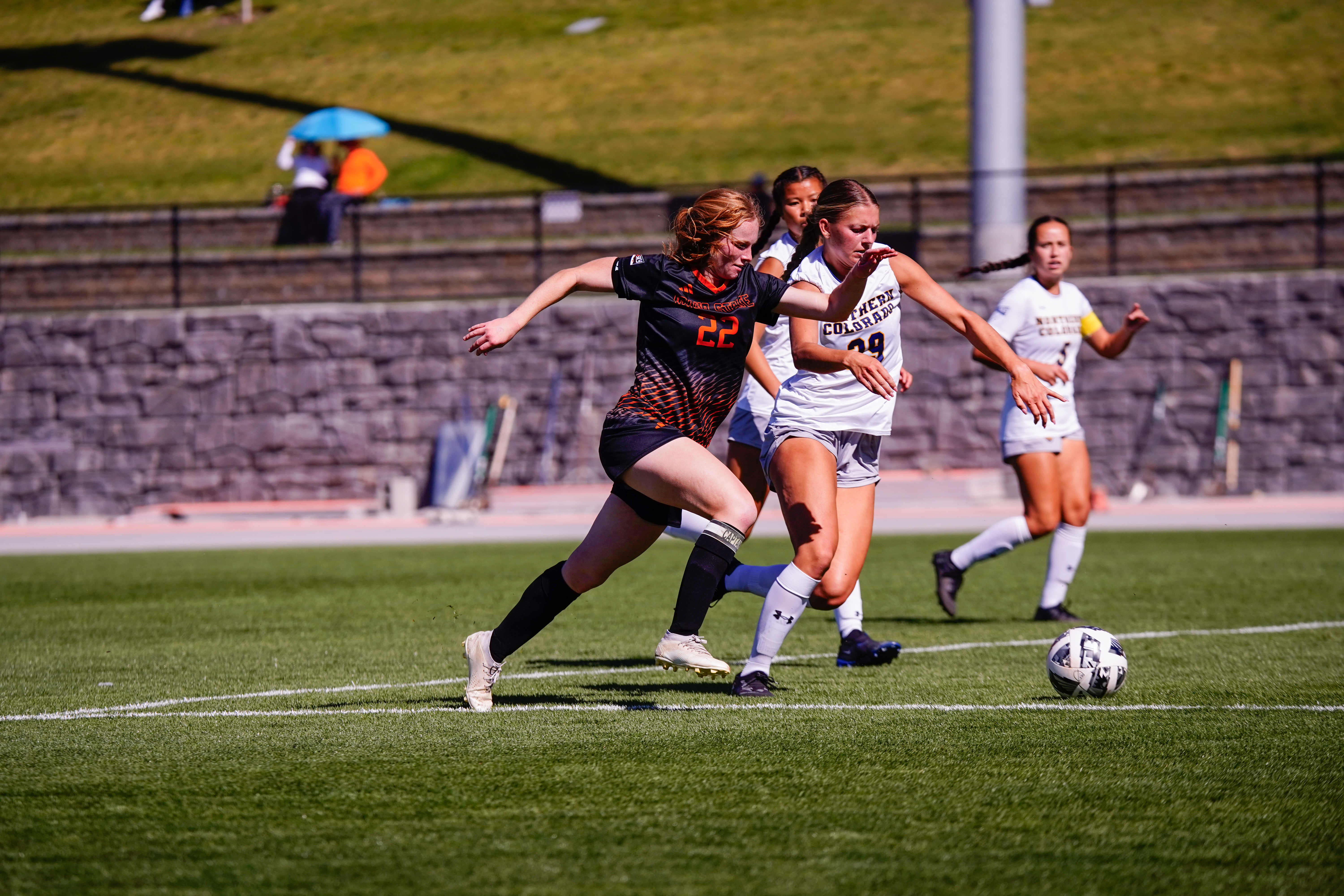 female students playing soccer