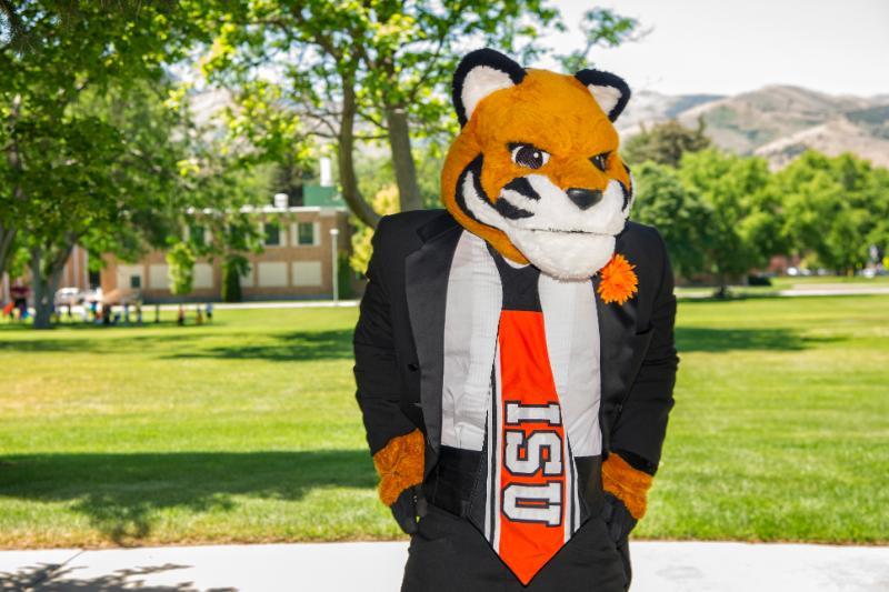 Benny Bengal wearing a suit standing outside