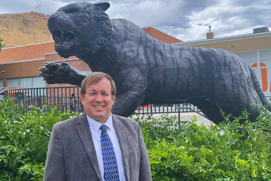 Francom stands in front of the bengal statue