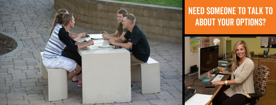 Need someone to talk to about your options? Photo is 5 students talking at a table outside of the Rendevouz building and another photo of a girl working at a computer.