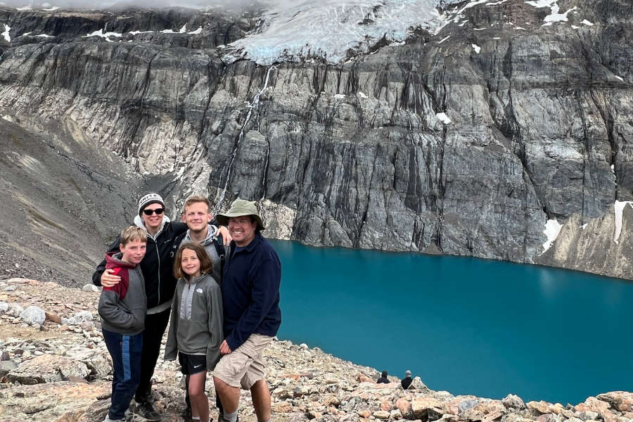 Francom and wife and three kids stand at the foot of a glacial lake