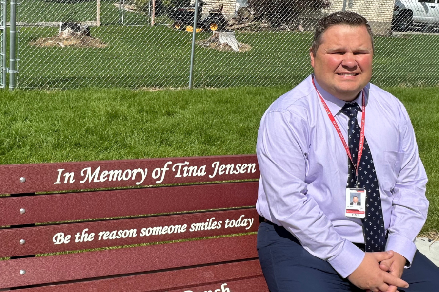 Jason Moss sits on a bench at the school