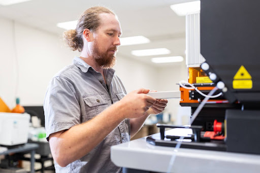 Christian Gattung, a master's student studying anthropology, loads samples into ISU's new mass spectrometer and laser ablation system