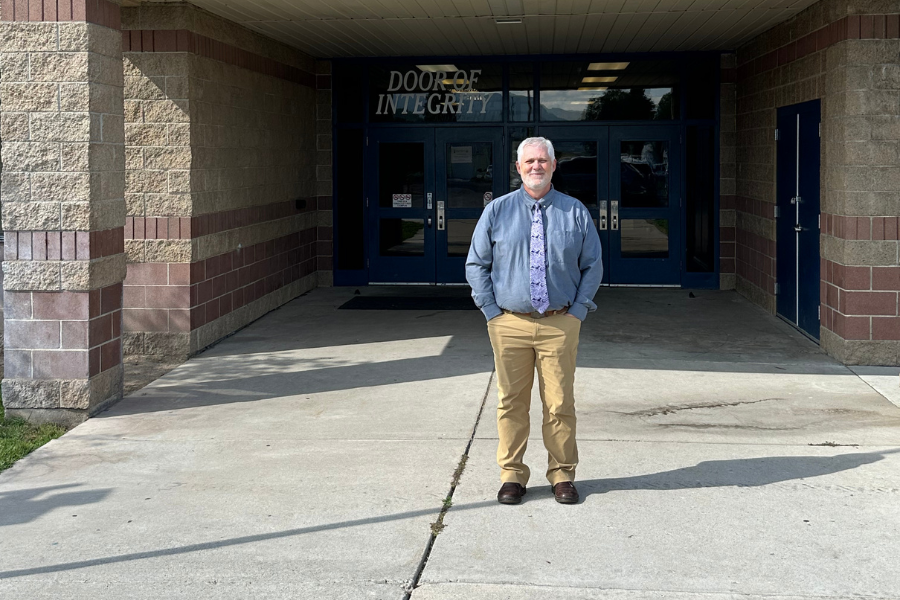 Scott stands at the entrance to the Soda Springs school