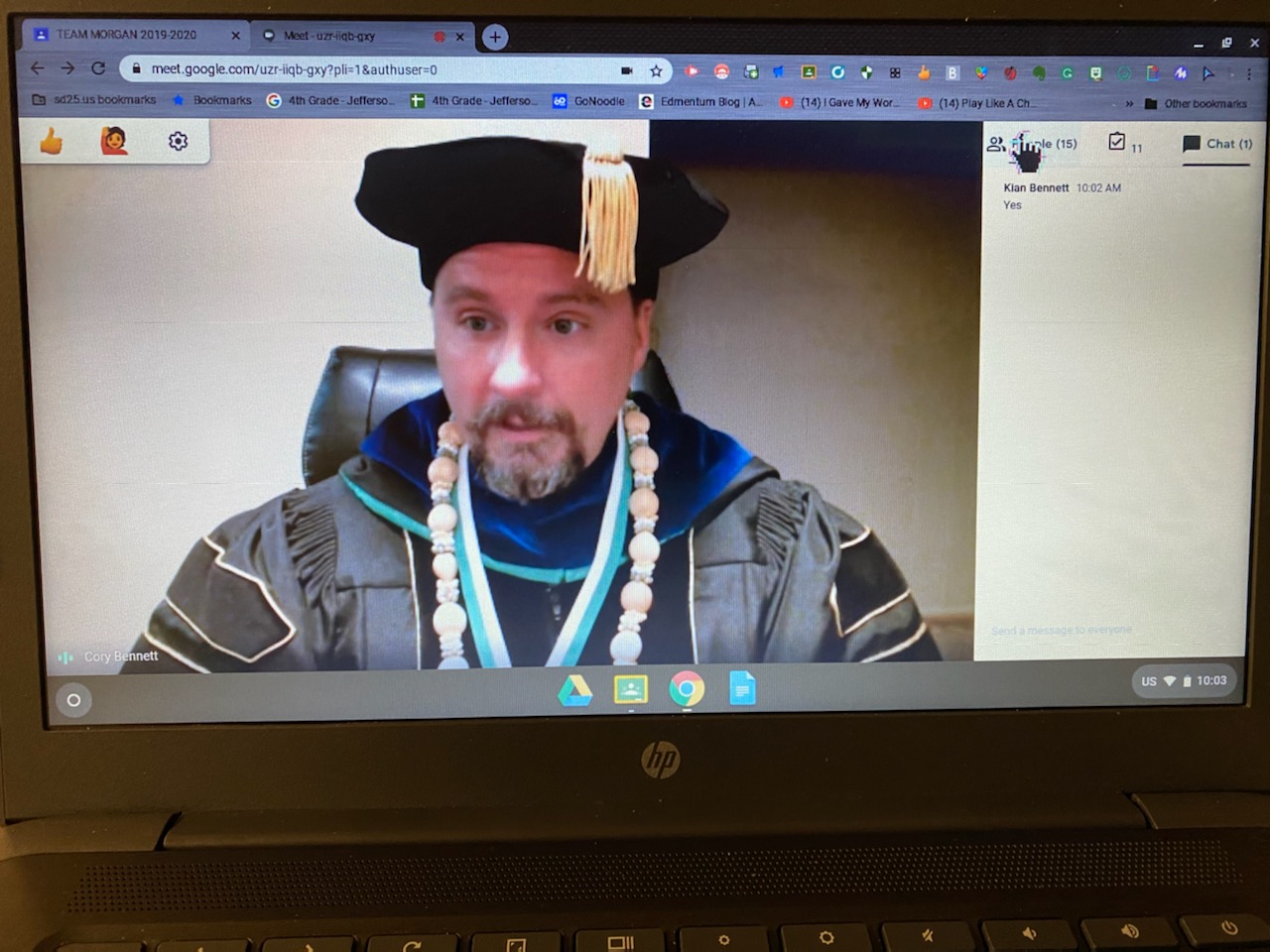 Dr. Cory Bennett dressed in regalia for zoom Mystery Guest