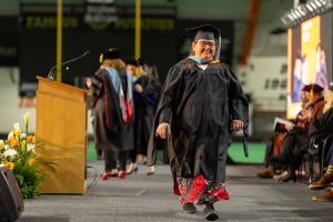 Idaho State University College of Education Deaf/hard-of-hearing graduate student completes a graduate program and walks across stage at the winter commencement ceremony. 