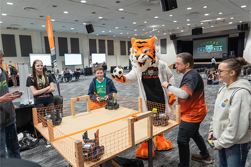 Benny the Bengal starts a robot soccer game at Bengal STEM Day 2026.