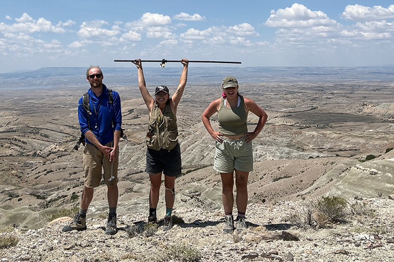 Kurt Sundell, left, Cheyenne Bartelt, middle, and Macy Zweigart, right, after completing their field campaign in the greater Green River Basin. Cheyenne is holding a Jacob's staff which is a tool commonly used in geology to measure stratigraphy.