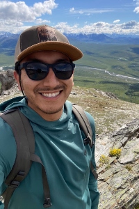 Daniel Vega taking a selfie next to a valley