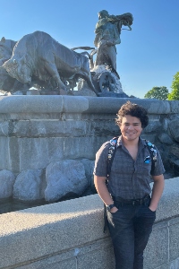 Tobias Babcock standing in front of a fountain in Denmark