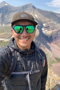 Daniel Vega taking a selfie in front of a valley