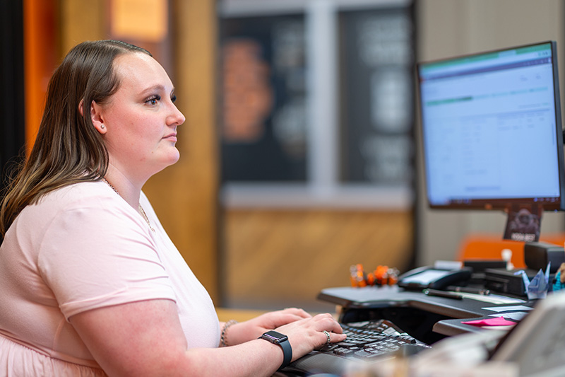 Health Information Technology Student working on a computer
