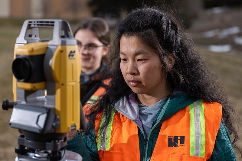 Civil Engineering Technology student working with equipment