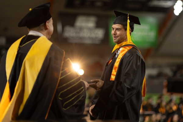 Graduate student receives his diploma