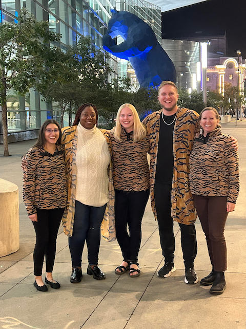 5 smiling individuals wearing tiger stripes. They are the Fall 2023 second year cohort.