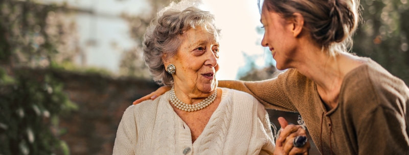 A young woman helping an elderly woman