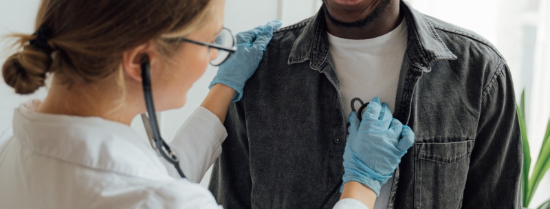 Health professional using a stethoscope on a patient