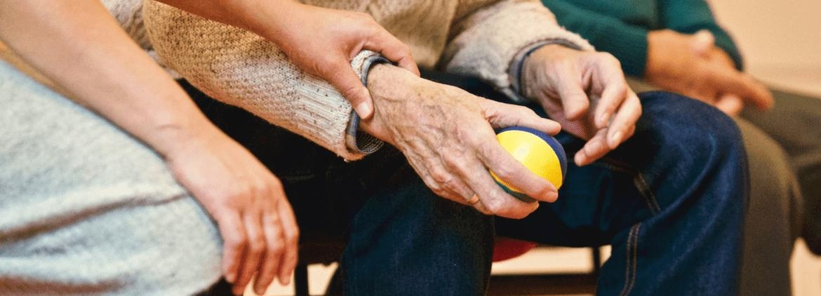 Community health worker helping elderly patient.