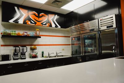 inside fueling station with refrigerator, washing sinks, and smoothie makers visible.