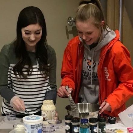 Two Nutrition and Dietetic students prepare healhy snacks at community health fair