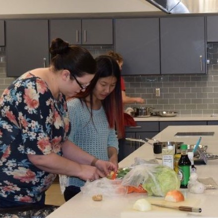 Four nutrition and dietetic students preparing an international meal