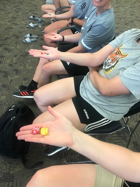 ISU women's soccer team holds a few pieces of candy during mindfulness and diet exercise