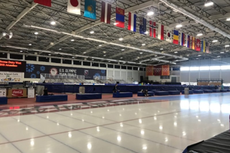 Rink at Olympic Oval: Speed Factory with flags flying from ceiling from many different countries