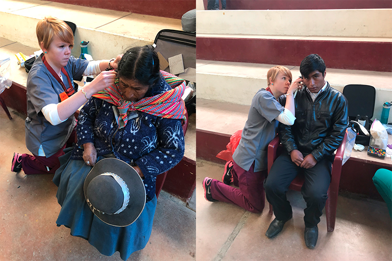 ISU audiology student Bailey Neuhaus conducting a hearing screening for a older woman and young man, Peruvian villagers
