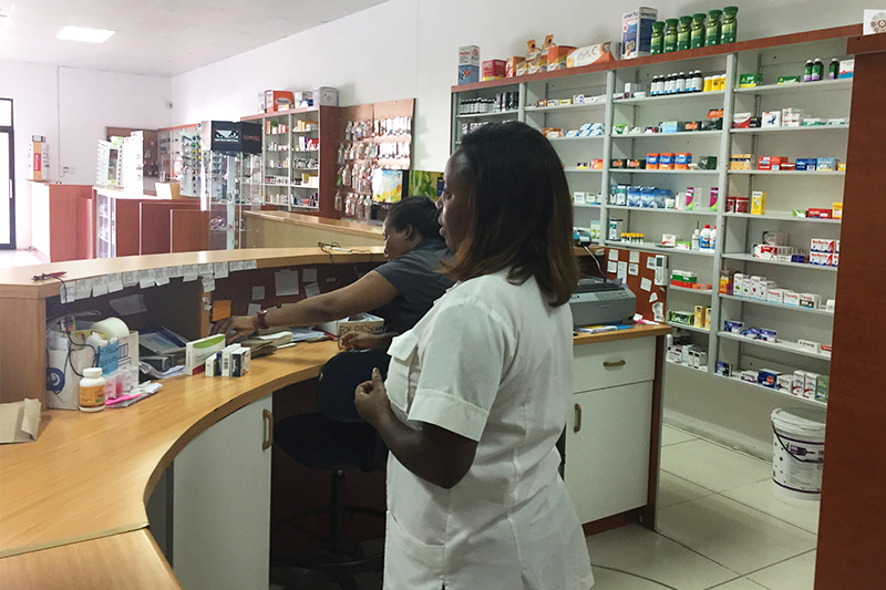 Two women work behind the counter at a pharmacy in Namibia, where Dr. David Hachey recently completed a sabbatical