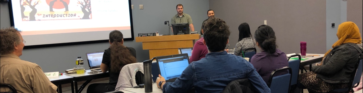 Students sitting looking at two instructors teaching a training.