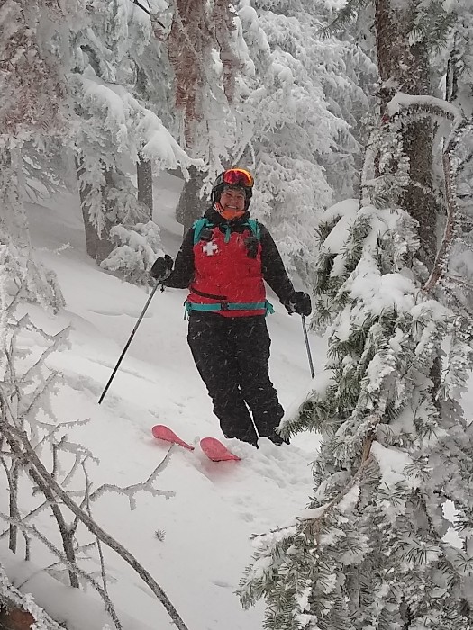 Faculty AJ Weinhold on Snowy Mountain in Ski Patrol gear