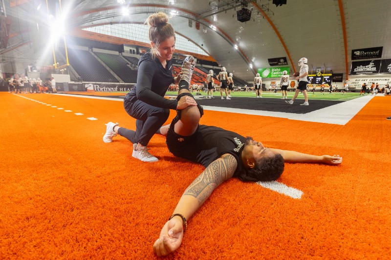 Athletic training treating football player on field