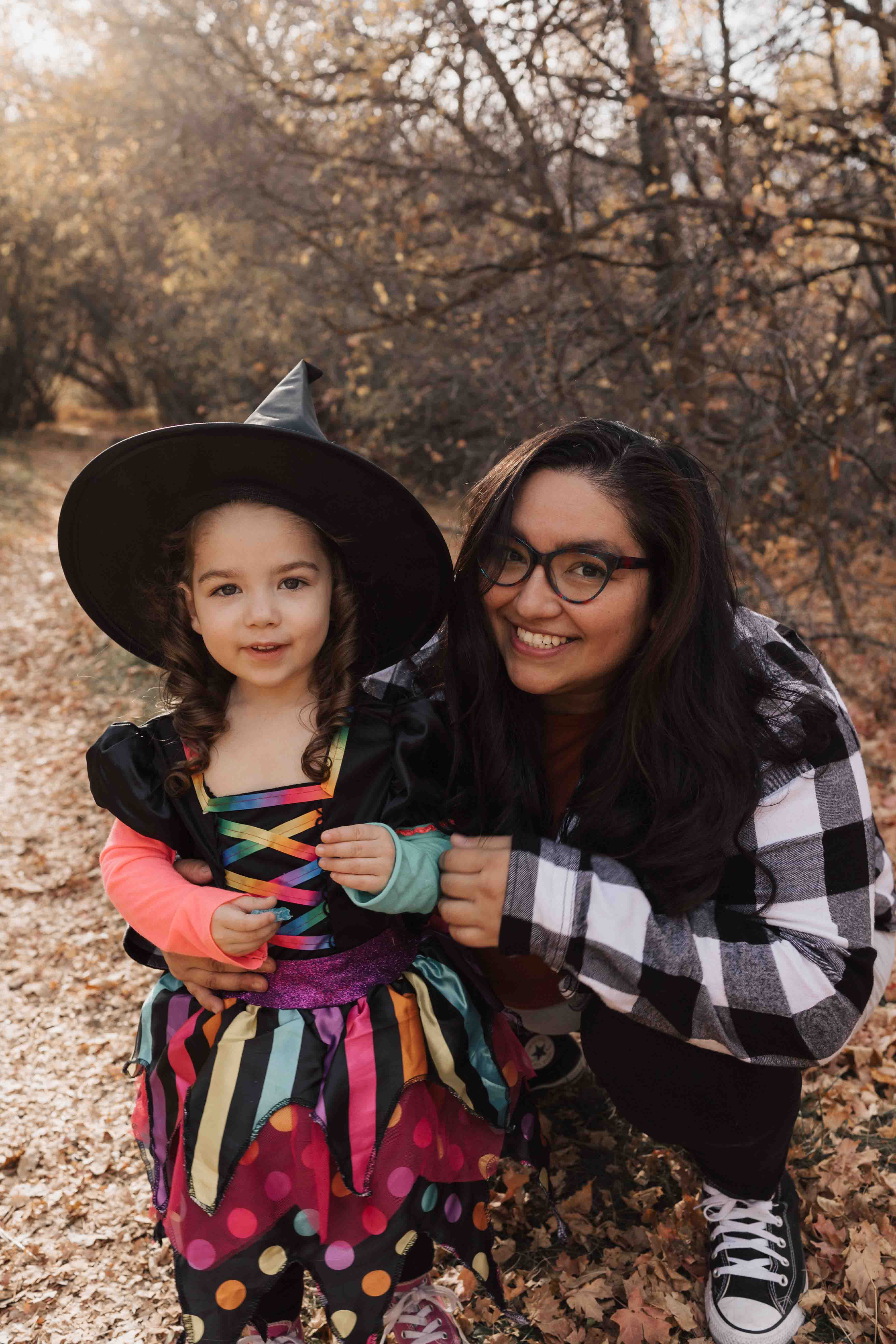 Amanda Lettig next to a small child dressed as a witch