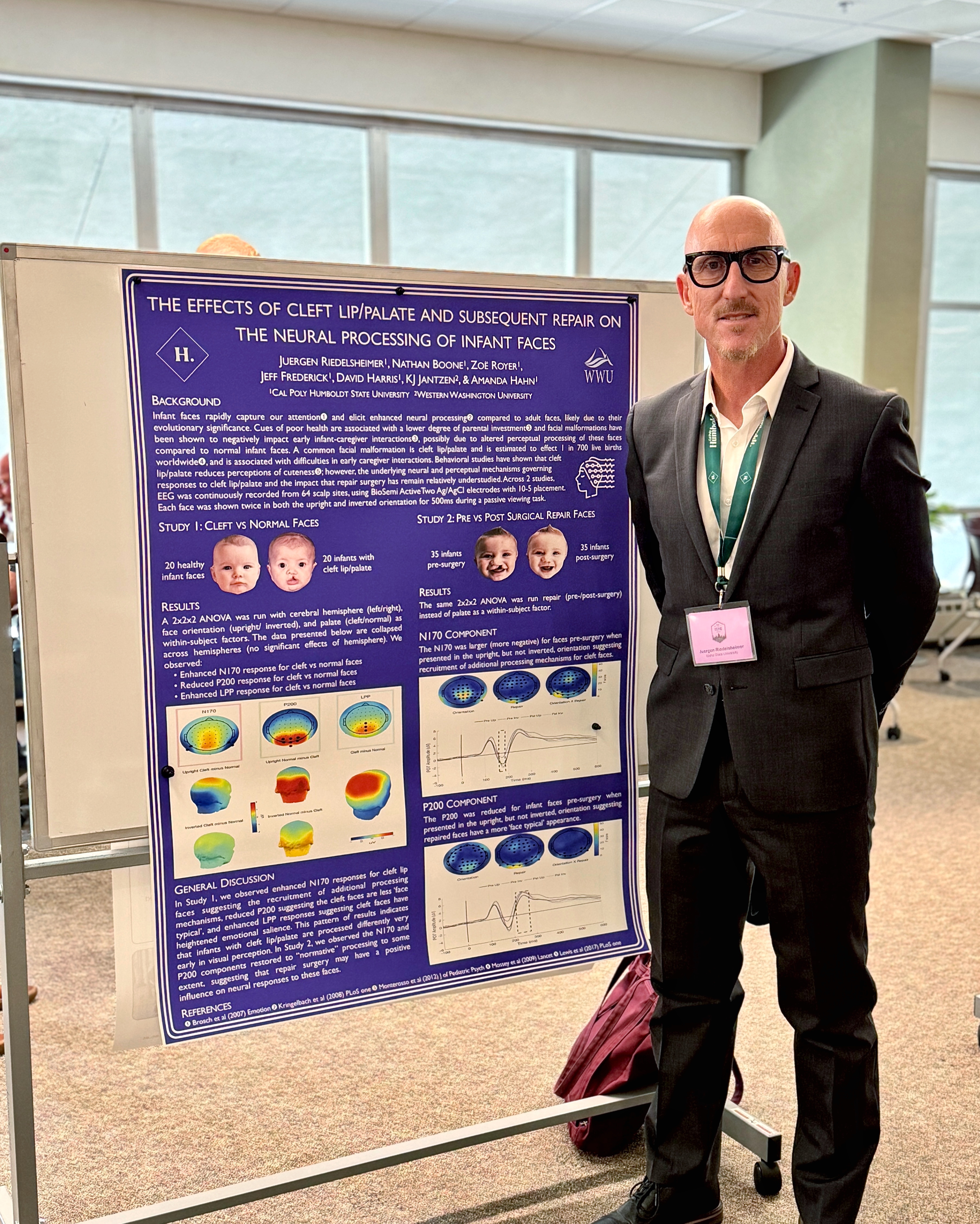 Juergen A. Riedelsheimer standing in front of his research poster at a conference