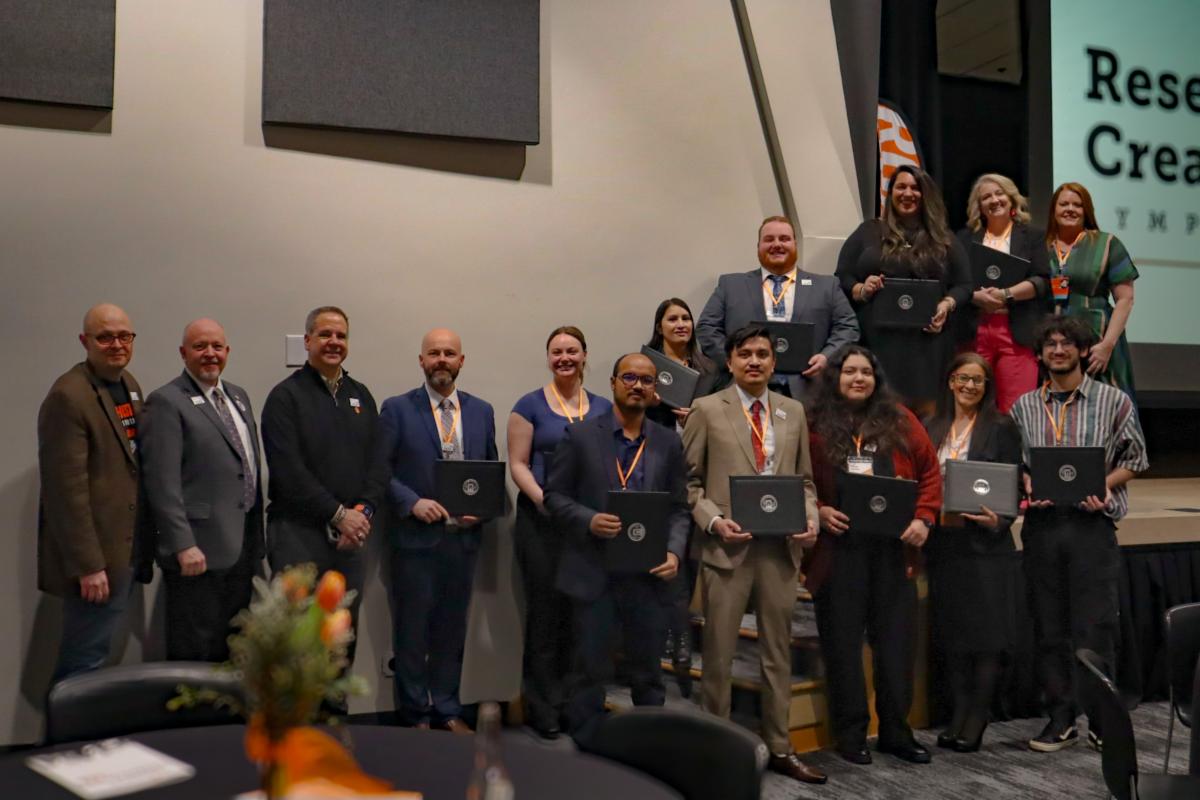 2025 Symposium Winners posing with their awards