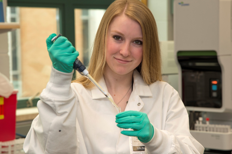 A female student using a pipette