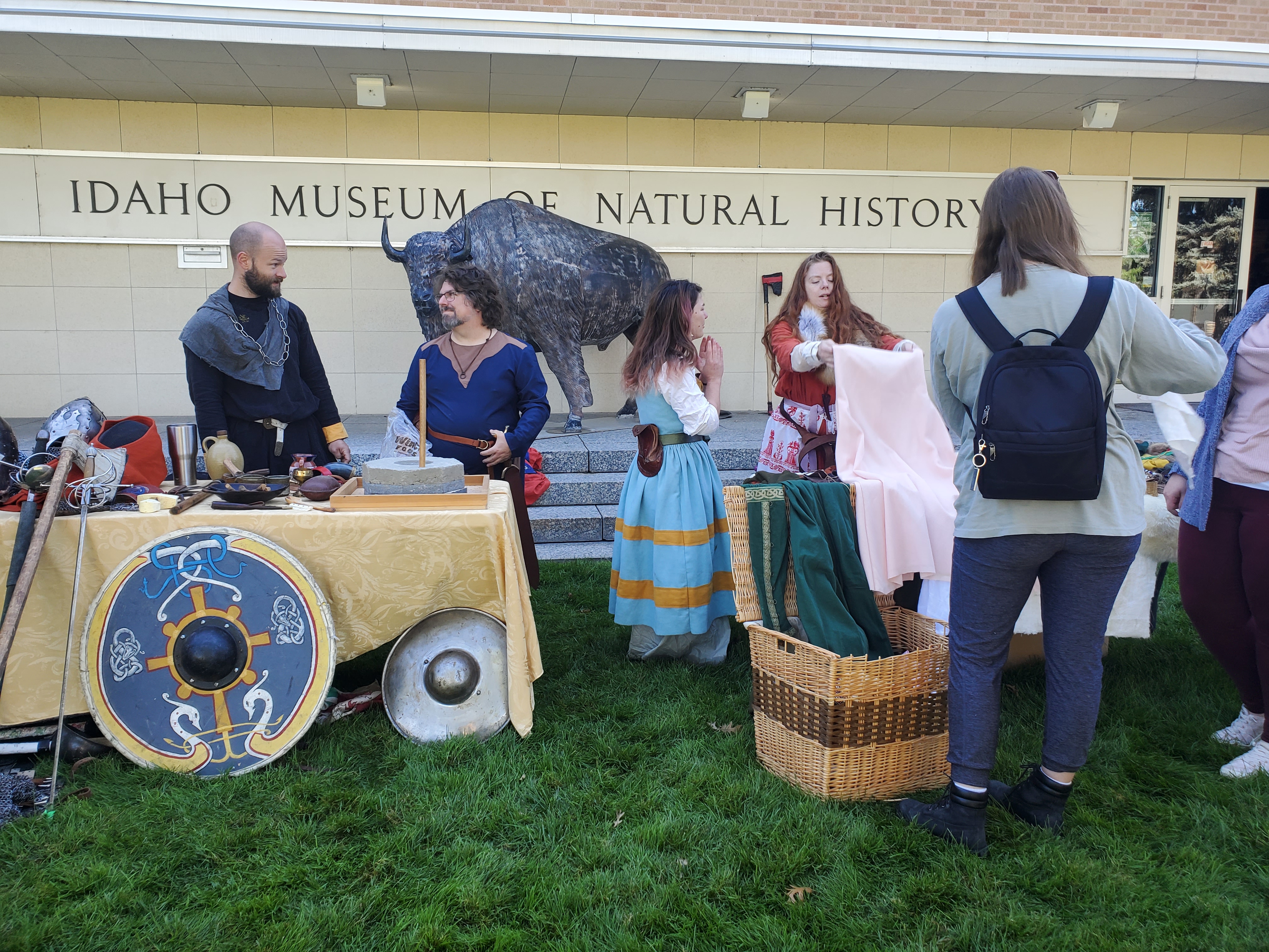 Men and women dressed in medieval garb for a mabon celebration in front of the idaho museum of natural history