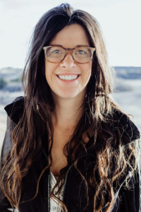 Woman with glasses and long dark hair