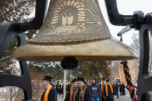 Graduates passing by bell