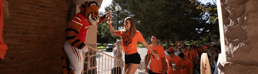 New students marching through the arch