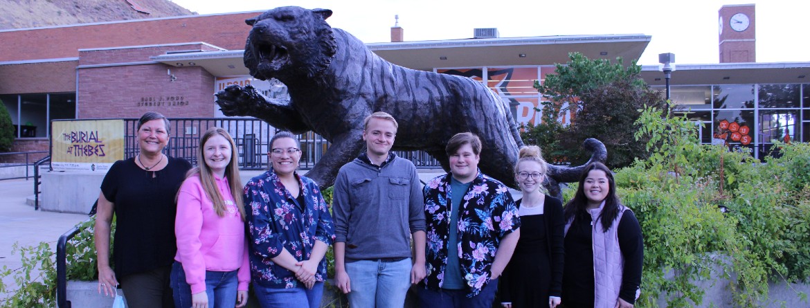 Instructor and students of Peer Advising course in front of student center.