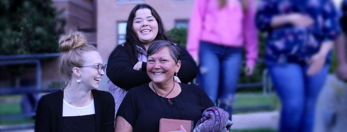 Instructor and Peer Advisors standing in front of Graveley Hall.