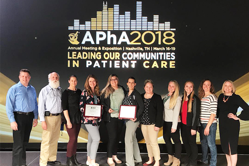 Students and faculty from the ISU College of Pharmacy pose on stage with their 1st, 2nd, and 3rd place awards at the annual APhA-ASP meeting and expo in Nashville, TN in March 2018