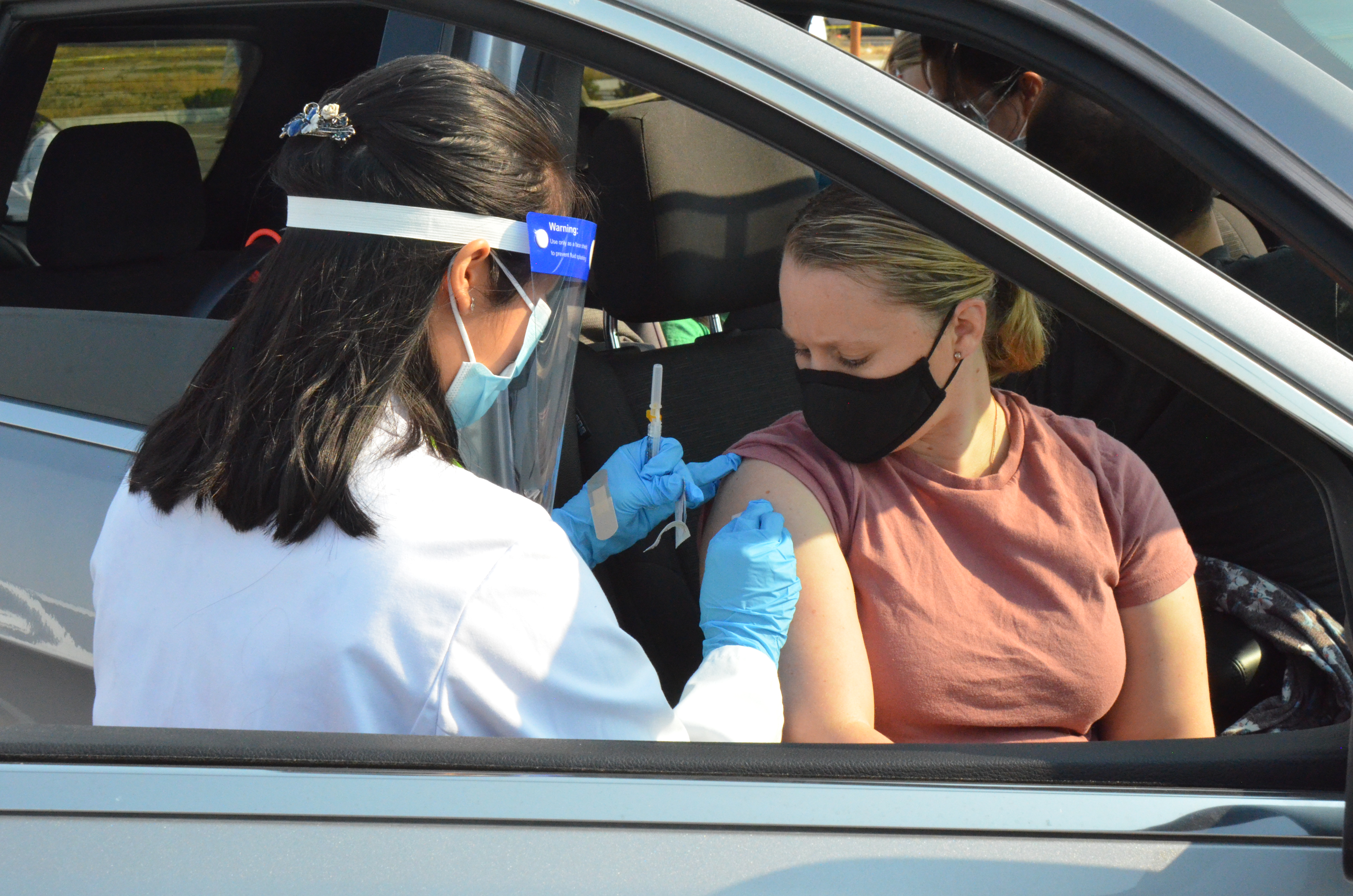 Woman receives flu shot in car from ISU student pharmacist