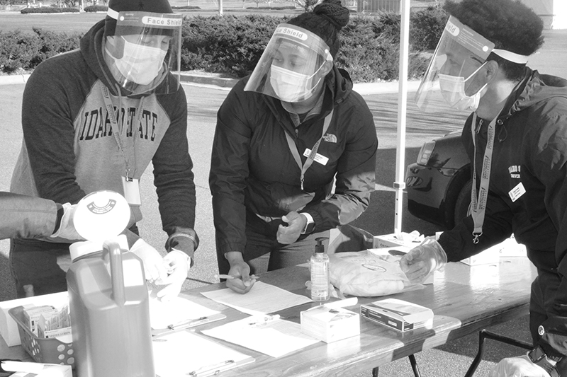 student pharmacists administer immunizations at a community event