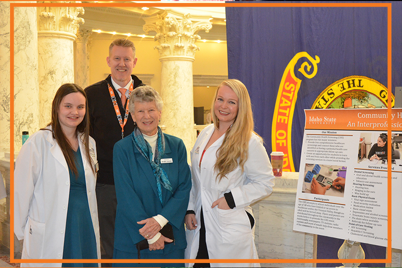 Interim Dean Chris Owens with Idaho Senator Regina Bayer and student pharmacists in white coats at the annual pharmacy day at the capitol